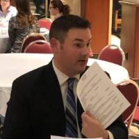 An alumnus discussing resumes and cover letters at the Cover Letter and Resume Roundtable Event